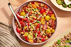 a large bowl filled with lots of different types of food on top of a table