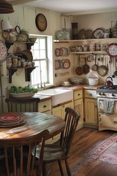 an old fashioned kitchen with lots of plates on the wall and cupboards full of dishes