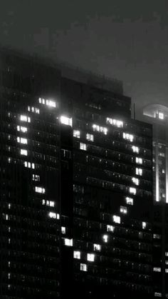 black and white photograph of skyscrapers at night