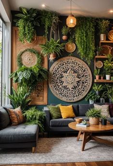 a living room filled with furniture and lots of plants hanging on the wall above it