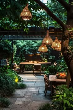 an outdoor dining area with lights hanging from the ceiling and plants growing on the ground