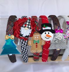 a group of christmas decorations sitting on top of a wooden shelf next to each other