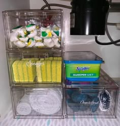 three clear containers filled with cleaning supplies on top of a table