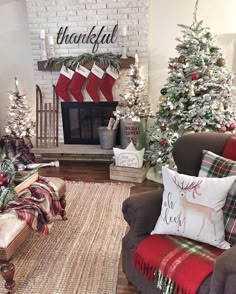 the living room is decorated for christmas with stockings and trees