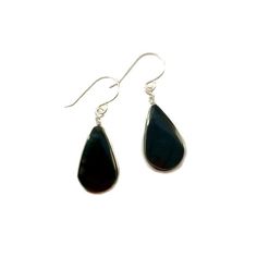 These black stone earrings include two genuine Obsidian stones from Peru dangling beneath a feminine French ear wire. The black, teardrop shaped semiprecious gemstones have a grooved edge in which the premium quality metal wire is wrapped. Choose your finish: 925 Sterling Silver or 14K gold fill.The wirework is handwoven in my art jewelry studio on the beautiful island of Martha's Vineyard. The earrings are approximately 1.25 inches long as measured from the center of the French ear loop to the Black Drop Jewelry, Modern Black Sterling Silver Earrings, Classic Black Earrings With Polished Finish, Black Teardrop Modern Jewelry, Modern Black Teardrop Jewelry, Classic Black Drop Jewelry, Modern Black Long Drop Jewelry, Black Teardrop Gemstone Jewelry, Modern Black Drop Earrings