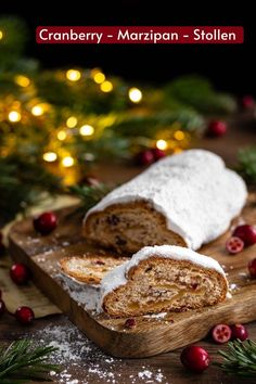 cranberry - marzipan - stollen with powdered sugar on a cutting board