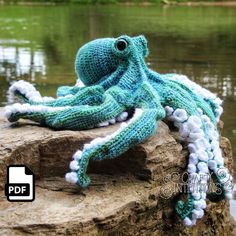 an octopus stuffed animal sitting on top of a rock