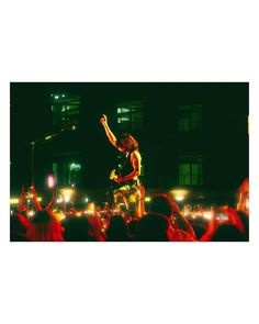 a man standing on top of a stage in front of a crowd