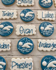 decorated cookies with words and images on them are arranged in the shape of dolphins