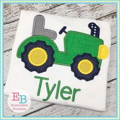 a green tractor with the word tyler on it's back and yellow wheels is shown