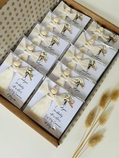 a box filled with lots of cards next to some dried grass and flowers on top of a table