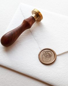 a wax stamp on top of an envelope with a wax seal in the middle and a rubber stamp attached to it