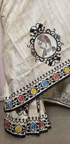 an embroidered white sari with multicolored designs on the border and black border