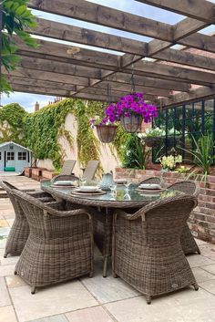 Stylish, elegant, traditional rattan garden furniture - 6 dining armchairs and oval dining table, and modular sofa with matching coffee table and glass top.