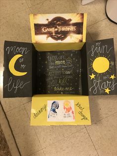 the game of thrones box is open and has writing on it, along with other items