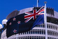 two flags flying in front of a building