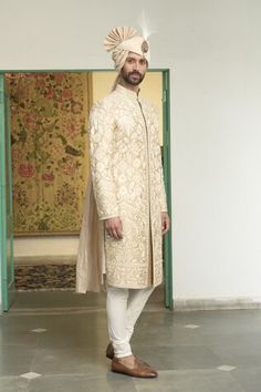 Beige sherwani featuring kashmiri thread embroidered floral blossom and vine motifs. Comes with inner kurta and churidar. - Aza Fashions Raw Silk Sherwani With Cutdana For Reception, Reception Raw Silk Sherwani With Cutdana, Traditional Fitted Churidar With Naqshi, Fitted Sherwani With Chikankari Embroidery For Transitional Season, Ceremonial Chikankari Sherwani For Diwali, Traditional Sherwani With Dabka, Traditional Fit Sherwani With Dabka Detailing, Traditional Naqshi Kurta For Reception, Fitted Sherwani With Naqshi In Traditional Drape