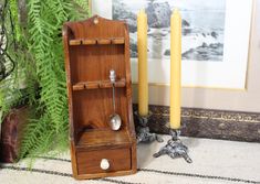 a wooden shelf sitting next to two candles