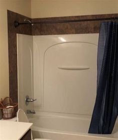 a bath tub sitting next to a toilet in a bathroom