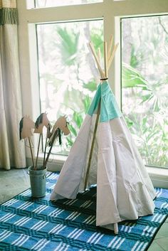 a teepee sitting on top of a blue rug