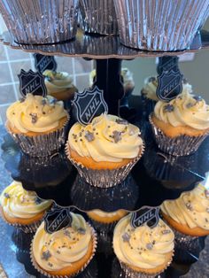 cupcakes with frosting are arranged on a cake stand