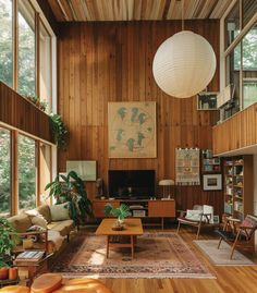 a living room filled with furniture and lots of wood paneling on the walls,