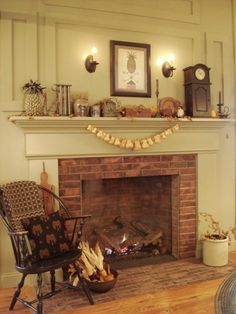 a living room with a fire place and chair next to an old clock on the wall