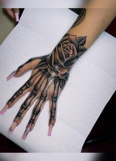 a person's hand with tattoos on it