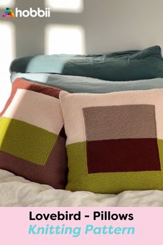 two pillows sitting on top of a bed with the words lovebird pillow knitting pattern