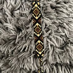 a close up of a tie on top of a furry animal's fur covered in beads