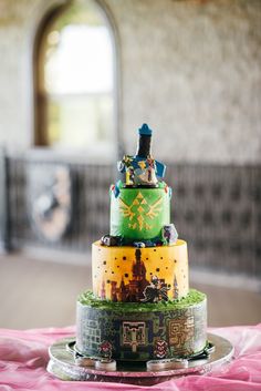 a three tiered cake is decorated with legos and princesses on it's sides