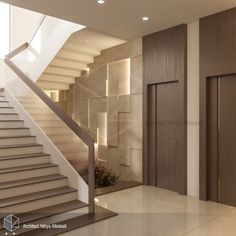 an empty room with stairs leading up to the second floor and another door on the other side