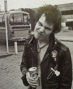 black and white photograph of a man with his mouth open holding a can of beer