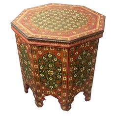 an ornately decorated wooden box with floral designs on the top and bottom, sitting against a white background