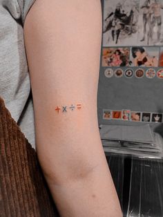 a person with a tattoo on their arm that says x = and is written in small letters