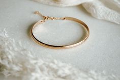 The Lola Cuff is oh-so-classic with a touch of sparkle! It’s perfect to wear to work, or your next date night. FEATURES 16K gold, rose gold or rhodium over brass base (tarnish resistant) cuff 14K gold-filled or sterling silver chain extender, adjustable length Tiny cubic zirconia stone All bracelet findings (clasp, chain, jump rings) are all gold-filled/sterling silver to ensure the highest quality piece. Classic Adjustable Rose Gold Bangle, Adjustable Rose Gold Bangle For Everyday, Classic Adjustable Cuff Bracelet For Party, Elegant Rose Gold Cuff Bracelet For Formal Occasions, Classic Adjustable Rose Gold Cuff Bracelet, Adjustable Elegant Rose Gold Cuff Bracelet, Classic Rose Gold Bangle For Everyday Wear, Classic Rose Gold Bangle For Everyday, Chic Rose Gold Bangle Bracelet