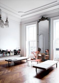 a living room filled with furniture and a chandelier