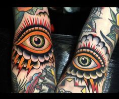 two people with tattoos on their legs and one has an all seeing eye in the center