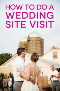 a man and woman standing in front of a barn