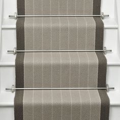 a set of stairs with beige and brown carpet