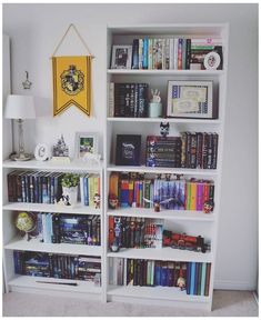 a white book shelf filled with lots of books