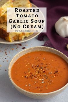 roasted tomato garlic soup no cream in a bowl with bread and garlic on the side