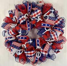 a patriotic wreath with red, white and blue bows