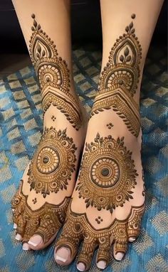 the feet are decorated with henna designs