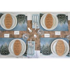 a table set with place settings and place cards