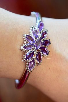 Metal: 14kt White Gold Weight Of Bangle Including Gems: 18.80 grams Stone: Amethyst Shape: Marquise-shape Amethyst Weight: Approximately 6.05 ctw Closer Type: Box Clasp With Safety Chain Width of Center Part Of Bangle: 21.28 mm Length of Center Part Of Bangle: 39.81 mm Bangle Width: 4.80 mm Inner Diameter: 2 1/4 in. Approximately Fits A 7 inch Wrist. Luxury Single Strand Amethyst Jewelry, Luxury Multi-stone Amethyst Jewelry, Luxury Amethyst Multi-stone Jewelry, Luxury Multi-stone Purple Jewelry, Luxury Purple Multi-stone Jewelry, Elegant Purple Jewelry With Polished Finish, Formal Purple Jewelry With Polished Finish, Formal Amethyst Jewelry With Polished Finish, Purple Gemstones With Polished Finish Fine Jewelry