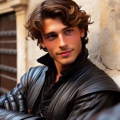 a young man leaning against a wall with his arms crossed