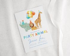 an animal themed birthday party card on a white background with streamers and a white ribbon