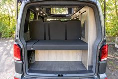 the back end of a van with seats folded down in it's cargo area