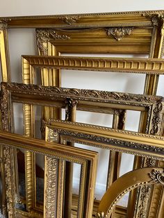 there are many gold frames on the floor